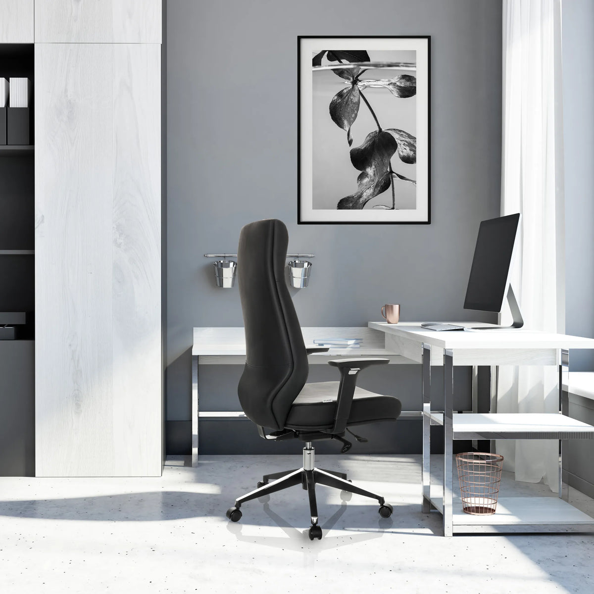 Professionell chefsfåtölj VITORO ECO i svart med högt ryggstöd och stjärnfot framför ett vitt skrivbord från hjh OFFICE
