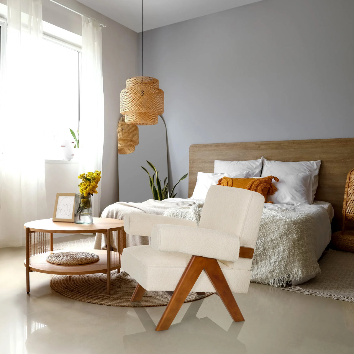 Vit POOLY loungefåtölj med träben i ett ljust sovrum från hjh LIVING