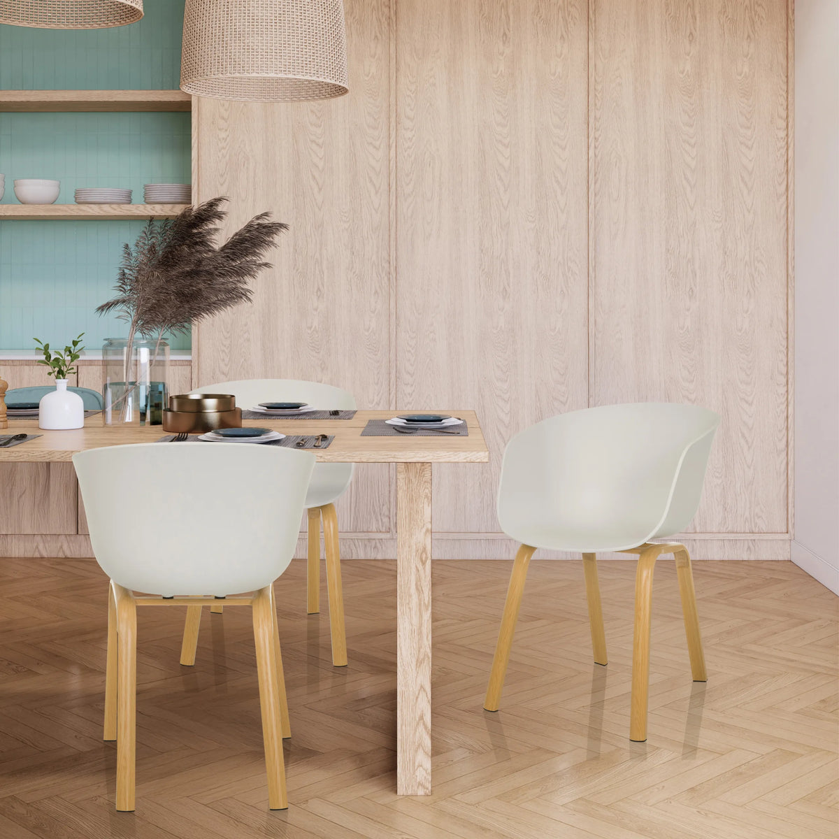 Vita skålformade stolar OSLO W med ljusa träben vid ett matbord från hjh LIVING