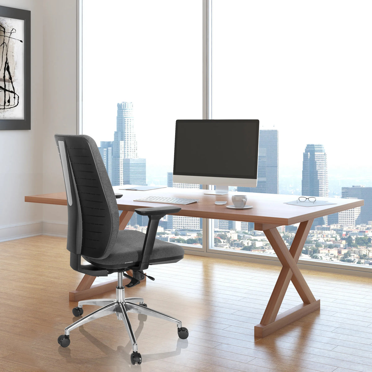 Professionell kontorsstol INTEGRIO I i mörkgrått vid ett skrivbord framför ett fönster med stadsvy från hjh OFFICE