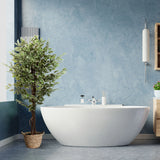 Kunstpflanze FICUS in Grün mit geflochtenem Korbgefäß vor einer blauen Wand von hjh OFFICE