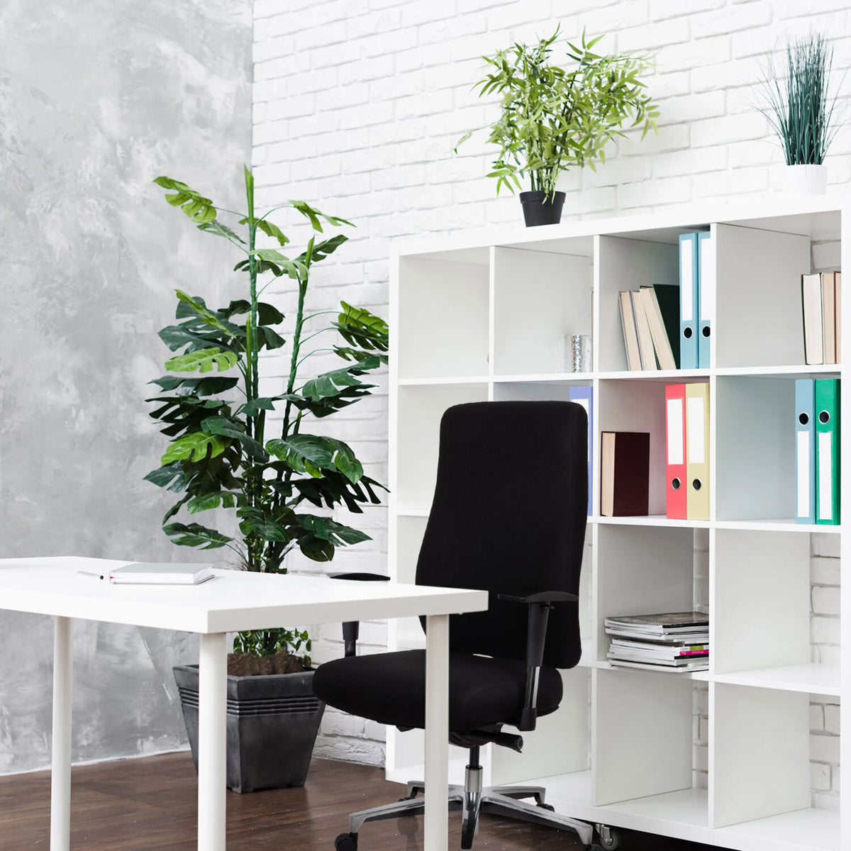 Svart Professionell kontorsstol FORCOM framför en vit hylla och ett vitt skrivbord från hjh OFFICE